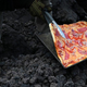 David Garcia checks a pizza he is cooking on the lava rivers that come down from the Pacaya volcano, May 2021